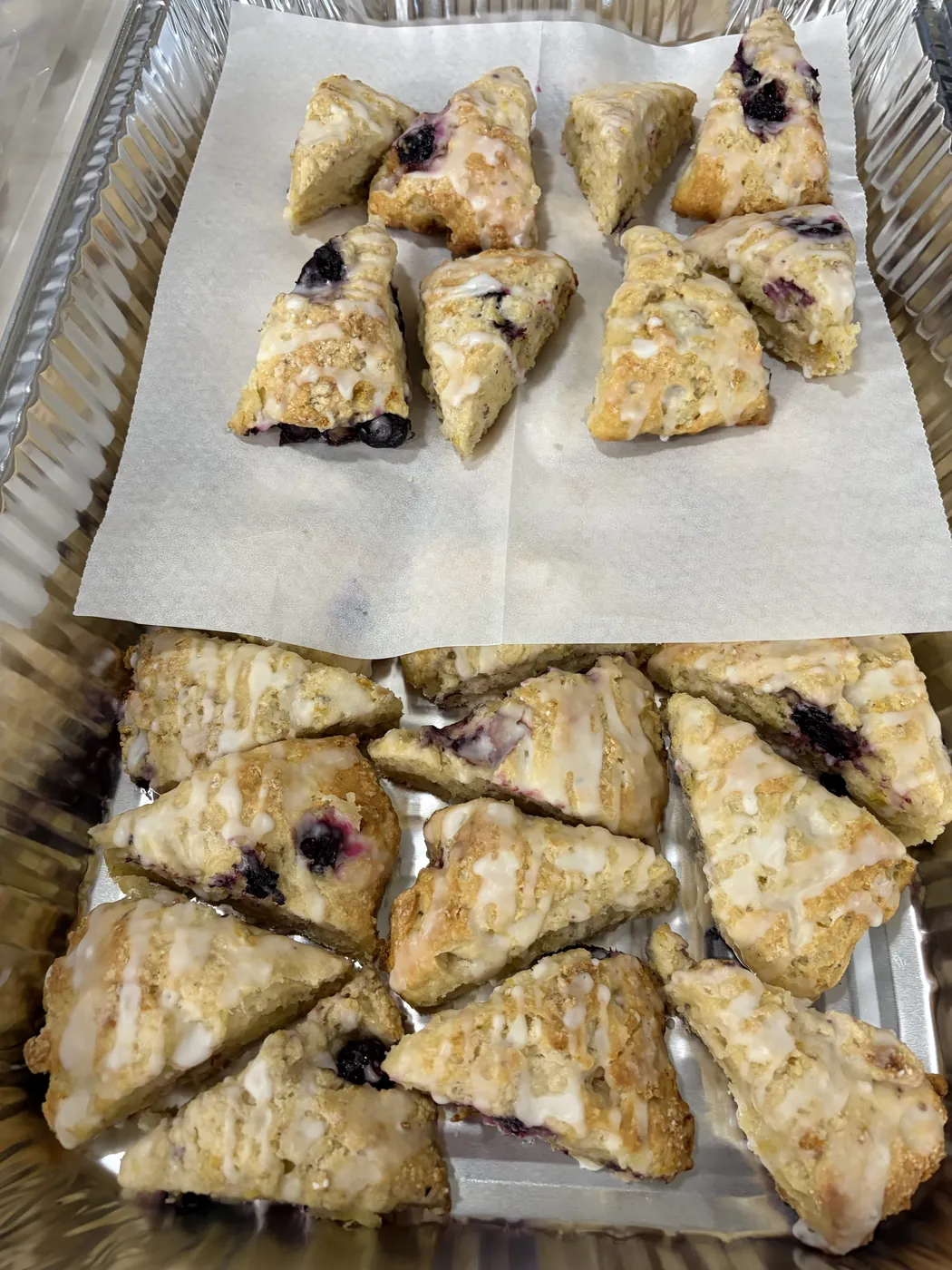 Tray of glazed scones, several with blueberries